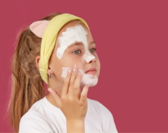 Teenage girl washing her face with gentle skincare cleanser